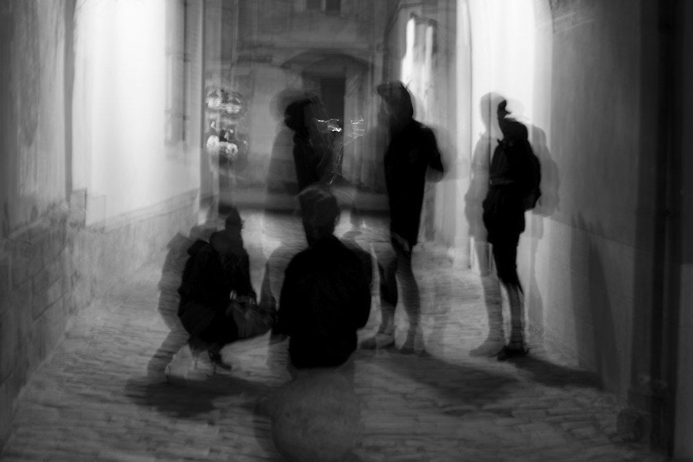 Figures walking down a long corridor