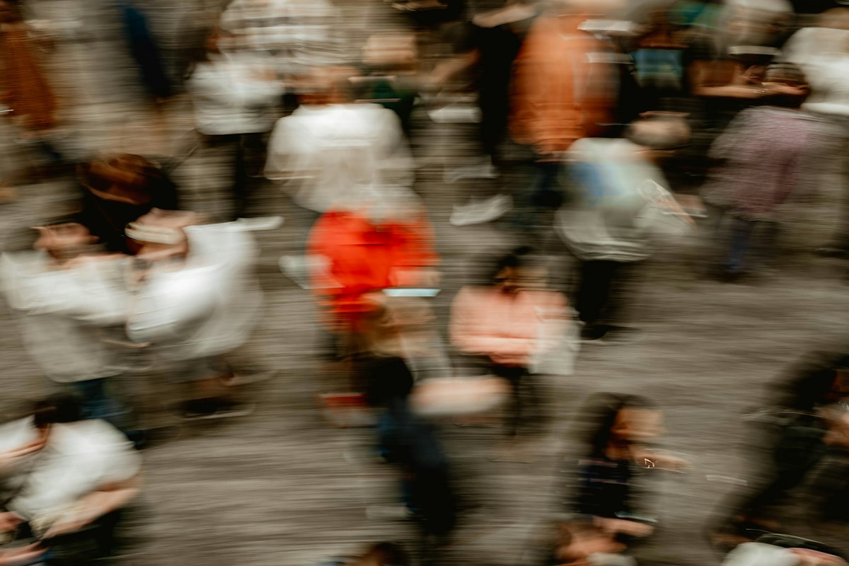 Motion-blurred crowd in warm light
